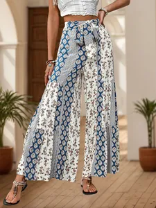 Detail of high waisted wide leg pants with bohemian floral print and matching waist tie