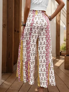 Detail of bohemian floral print and patchwork fabric on high waist wide leg summer pants