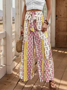 Detail of high waisted wide leg pants featuring bohemian print and waist tie belt