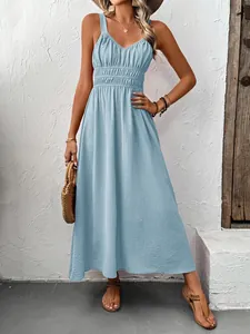 Detail of light blue pleated maxi dress showing textured fabric and cinched waistline