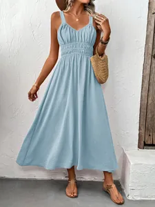 Detail of light blue sleeveless dress with textured fabric and elegant V-neck design