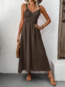 Close-up of textured pleated fabric and V-neck design on a brown sleeveless maxi dress