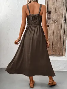 Detail of the back bow tie and smocked waist on this brown sleeveless maxi dress