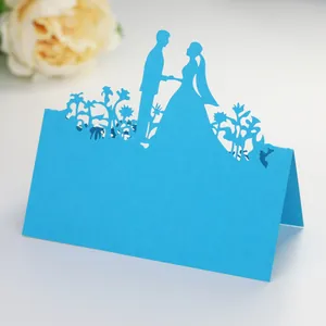 Detailed laser-cut light blue wedding place card featuring elegant bride and groom silhouettes