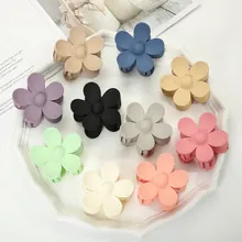Detailed set of ten matte flower hair clips in various colors displayed on a white tray