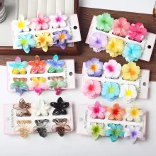 Detail of colorful mini flower hair claw clips in macaron colors on display cards