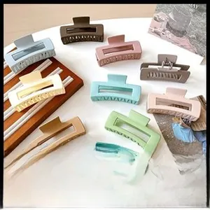 Flat lay of colorful matte rectangular hair claws in Morandi tones for hair styling