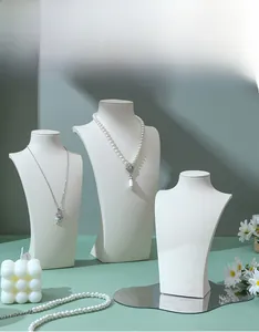 Three white PU leather neck busts for necklace display in various heights for jewelry shops