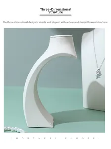Macro shot of white leather S-shaped necklace display stand with stereo structure detail