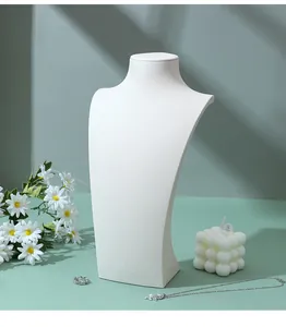 Macro detail of a white PU leather jewelry bust stand with fine frosted texture for necklaces