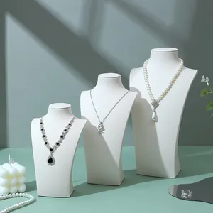 Three-piece set of white portrait bust necklace stands in varying heights for jewelry display