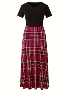 Détail d'une robe longue color-block avec haut noir et jupe longue à carreaux