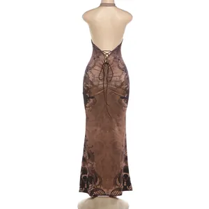 Back view of brown vintage print halter maxi dress featuring open back with ties