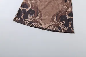 Detail of snake print dress hem featuring precise double-needle stitching and retro pattern