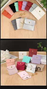 Detailed view of colorful velvet jewelry pouches with snap button closure and logo space