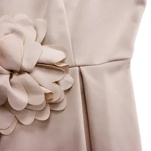 Detail der eleganten 3D-Stoffblume und Taillenfalten an dem rosa afrikanischen Kleid