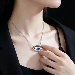 Macro shot of silver evil eye pendant necklace with blue sapphire and pavé diamonds