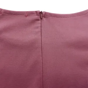 Detailaufnahme des verdeckten Reißverschlusses am dunkelrosa Kleid mit Textur