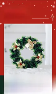 Close-up of artificial Christmas wreath with golden silk flowers and decorative red berries