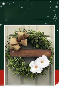 Artificial greenery wreath with linen bow and wood home sweet home sign decor