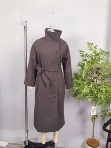 Detail of dark taupe wool coat featuring high stand collar and matching waist belt