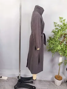 Close-up of a long dark wool coat featuring a stand collar and matching waist belt