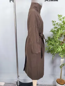 Detail view of brown wool coat featuring elegant stand collar and waist belt tie