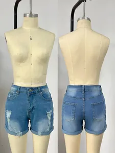Front and back detail of high-waist ripped denim shorts with rolled hems and light blue wash