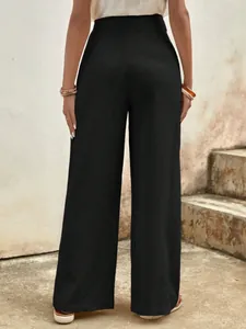 Detail view of high-waisted black wide-leg cotton pants with a smooth back silhouette