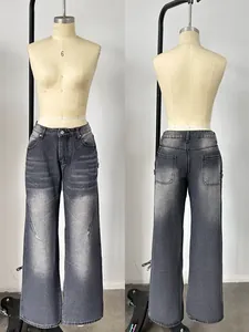 Detail of retro smoke gray washed denim jeans showing whiskering and distressed finish