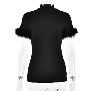 Detail of elegant black slim-fit top featuring stylish feather trim on the short sleeves