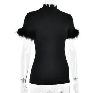 Detail of high neck black slim top featuring luxurious feather trim on short sleeves