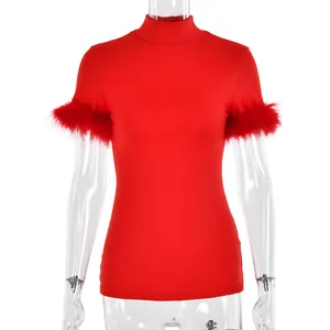 Close-up of red high-neck top featuring luxurious feather trim on the short sleeves