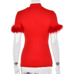 Detail view of red slim-fit top featuring stylish faux feather trim on the sleeves