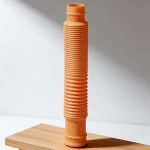 Macro shot of an orange sensory pop tube toy showing flexible corrugated plastic texture