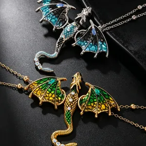 Macro view of flying dragon necklaces with blue and green enamel and rhinestones