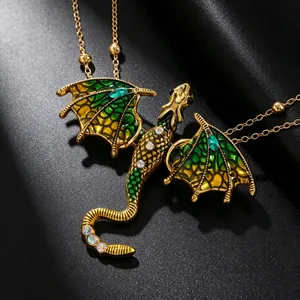 Detailed close-up of a dragon pendant with green enamel wings and sparkling rhinestones