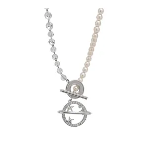 Asymmetric beaded pearl necklace with crystal beads and planet star pendant charm.
