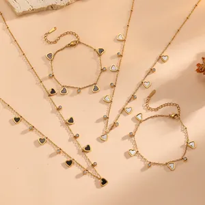 Detailed look at gold plated stainless steel heart charm necklace and bracelet jewelry set