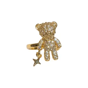 Sparkling gold-plated teddy bear ear cuff featuring a delicate hanging star charm