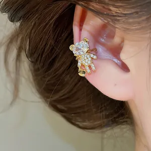 Close-up of a sparkling bear ear cuff with micro-pave crystals on a model