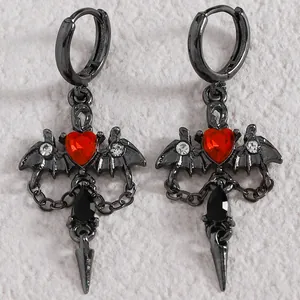Gothic Y2K bat wing earrings featuring red heart gems and black dagger charms