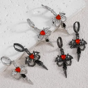 Gothic silver earrings with red heart gemstone, bat wings, and black dagger charms