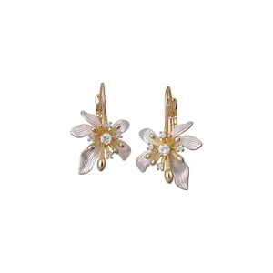 Elegant floral leverback earrings with white enamel petals and CZ stones.