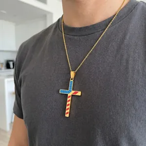 Detailed shot of a gold-plated stainless steel cross necklace with US flag pattern