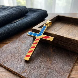 Detail shot of a gold-plated stainless steel cross pendant with American flag enamel pattern.