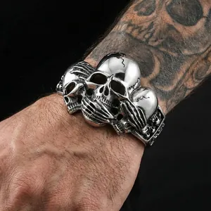 Gothic punk stainless steel skull bracelet with triple skulls and claw design on wrist