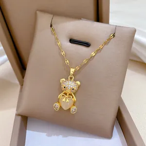 Luxurious gold bear necklace with sparkling rhinestones and heart shaped cat eye stone