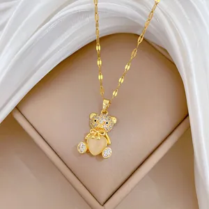 Elegant gold bear necklace with sparkling rhinestones and a heart-shaped opal pendant