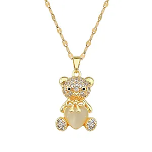 Golden titanium bear necklace featuring heart-shaped cat-eye stone and pavé zircon crystals
